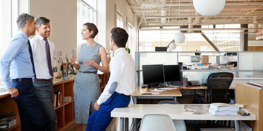 female manager in discussion with colleagues at work