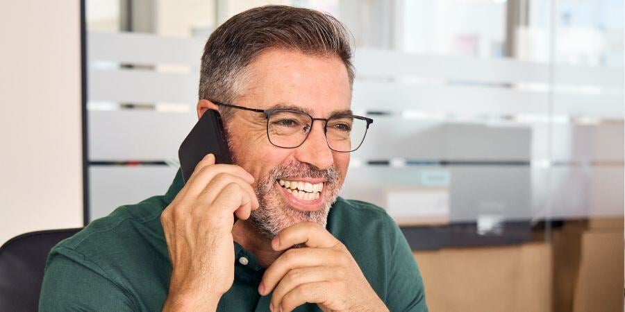 happy busy mature business man making phone call