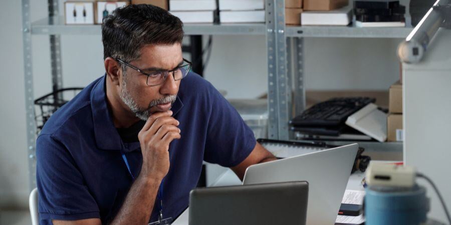 working thoughtfully at desk in modern office space